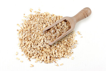 Wooden spoon on a pile of organic oat flakes, isolated on a white background with space for text. Packaging photograph
