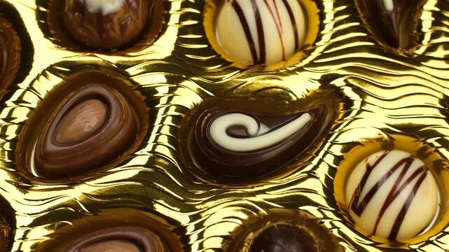 Chocolate candy in golden box macro, slider shot