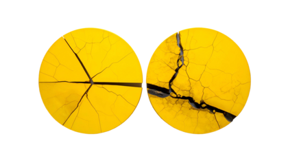 Two circular, cracked, bright yellow surfaces against a stark black background