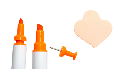 Orange highlighters, pushpin, and shaped sticky note against a black background