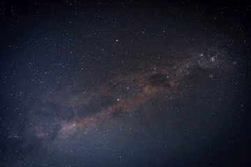 Fototapeta premium Starry night sky with visible Milky Way and star trails, creating a deep space background with cosmic motion and celestial atmosphere. Ideal for science, astronomy, and abstract space concepts.