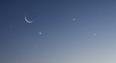 A crescent moon hangs in a clear, deep blue twilight sky dotted with distant stars.