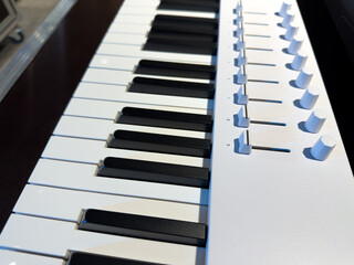 Control panel with sliders and knobs above main synthesizer keys. Musical instrument for creating electronic music. The art of playing synthesizer