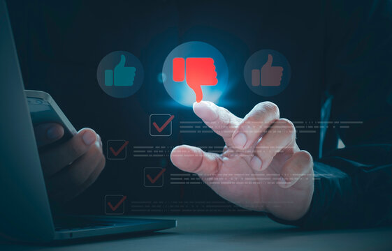 User typing negative online review with thumbs down icon for bad customer feedback, service criticism, and dissatisfaction impacting digital reputation while using smartphone and laptop device.