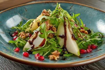 Fresh arugula salad with pear, pomegranate, walnuts, and balsamic glaze