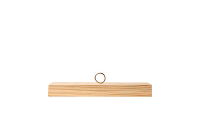 Close-up studio shot of a light-colored wooden object with a cylindrical metal piece on top against a black backdrop