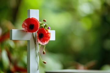 A white cross with red flowers on it