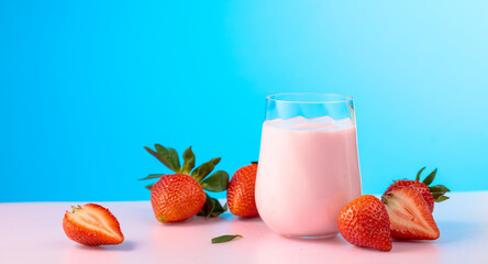 Strawberry yogurt and fresh berries on a colorful background.