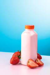 Strawberry milkshake smoothie in eco disposable jar and fresh berries.