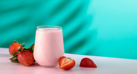 Strawberry yogurt and fresh berries on a colorful background.