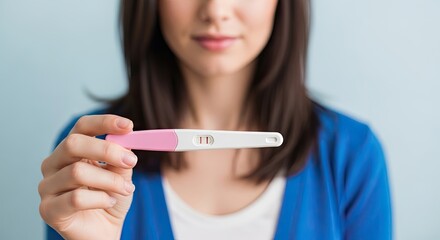 Anticipation of Life: A woman delicately holds a pregnancy test, a beacon of hope, revealing the dawn of a new life and the anticipation of motherhood. 