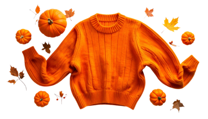 Bright orange sweater with pumpkins and autumn leaves, arranged on a dark background