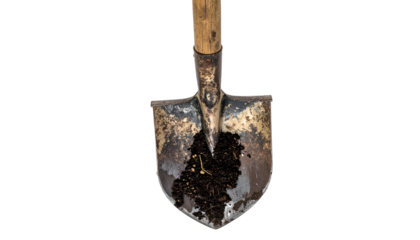 Close-up of a well-worn, dirt-covered shovel against a black background