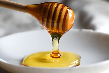 Golden Honey Dripping from Wooden Honey Dipper