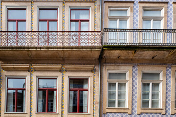 Fototapeta premium Facade of a 19th-century building, with its balconies and walls decorated with portuguese tiles. Porto, Portugal, 2023