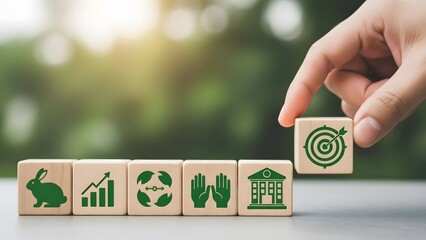Hand placing a wooden block with a target icon near eco friendly symbols