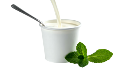 Creamy white liquid being poured into a paper cup with spoon and mint garnish