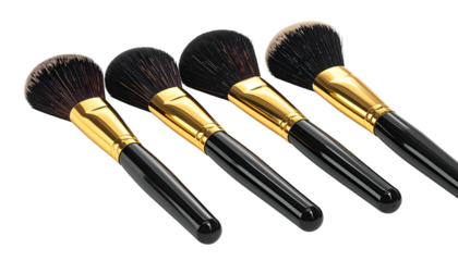 Four makeup brushes angled on a black background, with black handles and gold ferrules