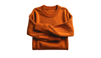 An overhead shot of a folded, burnt-orange sweater on a solid black background