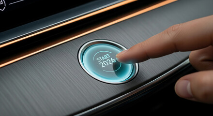 Close-up of a finger pressing a glowing blue start button with the year 2026 on a dark textured surface, representing future, new beginning, initiation