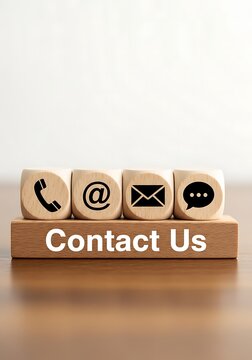 Wooden blocks with contact icons on Contact Us base