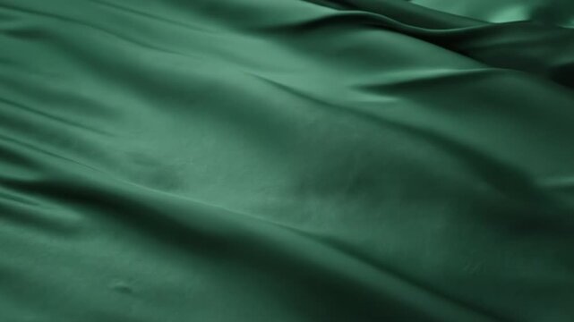 Green satin fabric texture with soft folds and subtle sheen creating elegant drape and calm mood emerald silk cloth draped fabric smooth surface flowing folds soft material textile background close