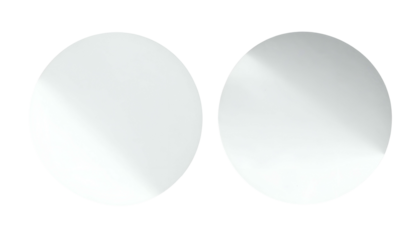 Two side-by-side, glossy, light-reflecting, perfect circles, against a stark black background