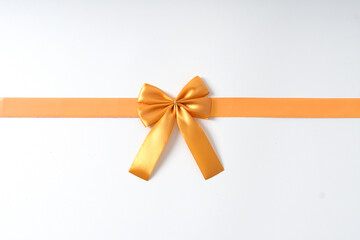 Fototapeta premium golden ribbon on white background, suitable for birthday, celebration and social media purposes.