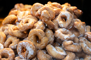 large pile of golden glazed donuts