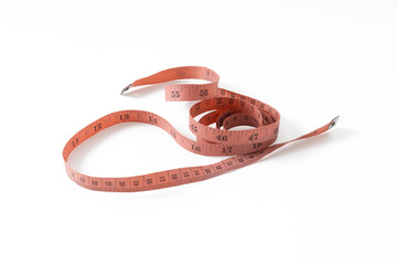 red measuring tape isolated on white background, usually used for measuring cloth or making crafts, and clothing