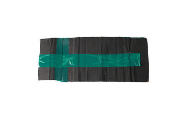 black cardboard pieces with green tape on white background