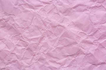Pink crumpled paper surface macro,pink crumpled paper background, texture for web design screensavers. Template for various purposes or creating packaging.