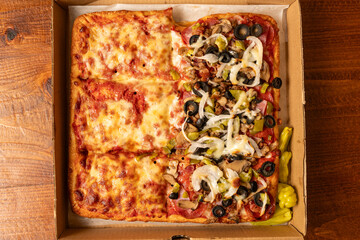 Sicilian pizza half with onions and olives and half plain