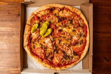 Pizza with tomatoes and sausage