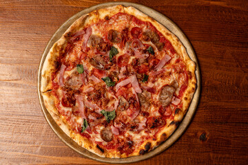 Pizza with sausage, bacon and ham