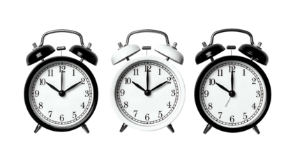 Three alarm clocks in a row, with varying times, set against a black background