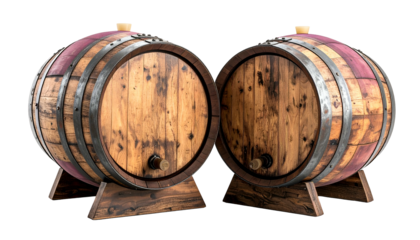 Two weathered wooden barrels with metal hoops, wood stands, and spigots