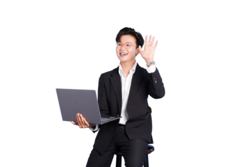 Asian Businessman Waving with Laptop: A dynamic young asian business professional, holding laptop, offers a friendly wave, conveying approachability and technological proficiency.