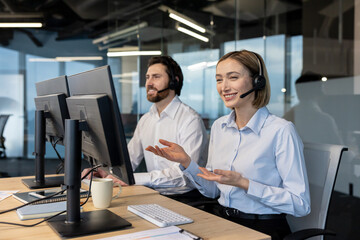 Smiling call center agents wearing headsets and working on computers, providing professional customer service, support, and communication in a modern office environment