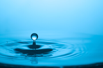 A single water drop creates ripples on the surface. Capture of the purity and beauty of water
