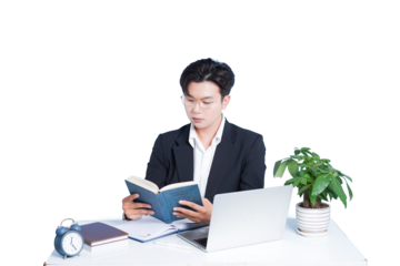 Focused Contemplation: A concentrated individual, engrossed in a book, meticulously studies at their desk, illuminated by the bright light.