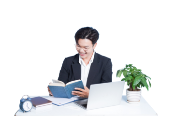 Focused Study: A young individual engrossed in his studies, illuminated by the glow of knowledge, reading a book in a modern workspace.