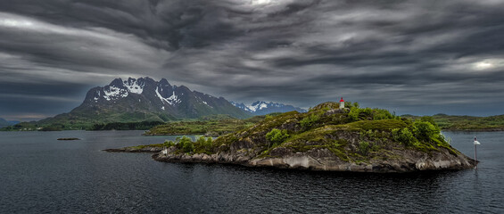 Coastal Landscape With Lighthouse And Snowy Mountains Near Stokmarknes At The Lofoten In Norway