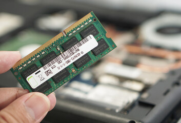 Technician Holding Laptop RAM Module for Replacement