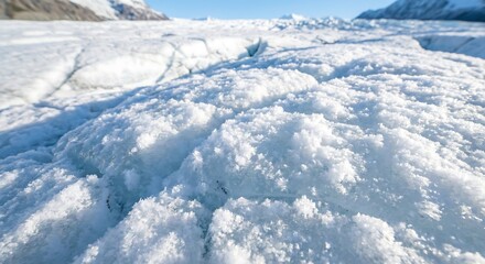 Fototapeta premium Glacier ice surface with rugged texture under clear blue sky