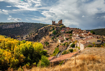 Fototapeta premium Pelegrina, village on a hill in Guadalajara, Spain. Castle ruins on hilltop next to Rio Dulce gorge