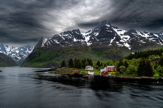 Coastal Landscape With Small Village And Snowy Mountains Near Trollfjord At The Lofoten In Norway
