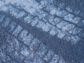 tire tracks on a road caused by muddy tires