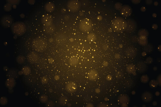 Glowing gold sparkles in light, golden glitter particles background