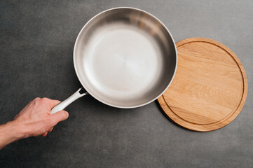 Stainless steel frying pan waiting on a kitchen countertop, ready to be used for cooking, close up